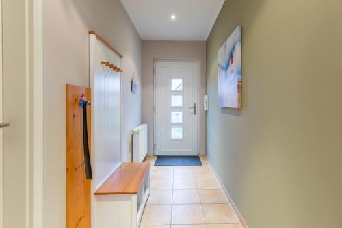 a hallway with a door and a tile floor at Ostseehaus Julia in Wohlenberg