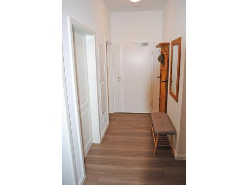 a hallway with a chair and a white door at Ferienwohnung in der Altstadt in Bad Bevensen