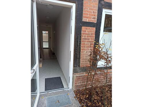 an open door of a brick building with a hallway at Ferienwohnung in der Altstadt in Bad Bevensen