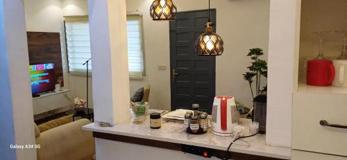a room with a kitchen with a counter and a door at Irina Blessed Homes Bonanjo in Douala