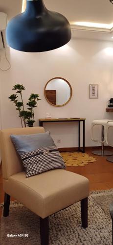 a living room with a chair and a mirror at Irina Blessed Homes Bonanjo in Douala