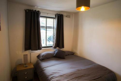 a small bedroom with a bed and a window at Spacious 3 Bedroom Home on South Shields Coast in Westoe