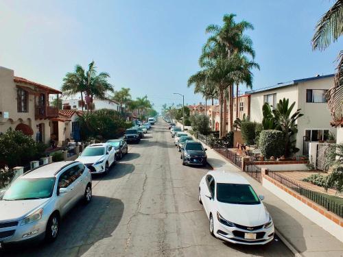 a row of parked cars parked on a street at Sand Sun & Second - Charming Studio within Walking Distance to Beach in Long Beach