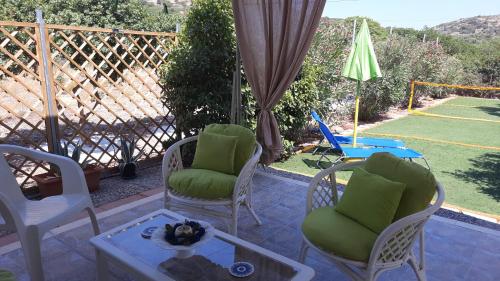 a patio with two chairs and a table at Monika's house in Chios