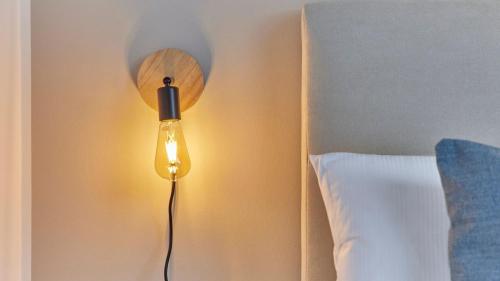 a lamp on a wall next to a bed at Neu!!! Moselbleibe Weingartenhaus in Bernkastel-Kues