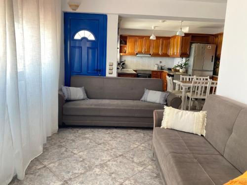 a living room with a couch and a kitchen at Porto Mare Apartment in Elafonisos