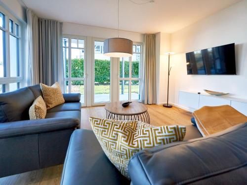 a living room with a couch and a table at Villa Beatrice - Wohnung 03 in Binz