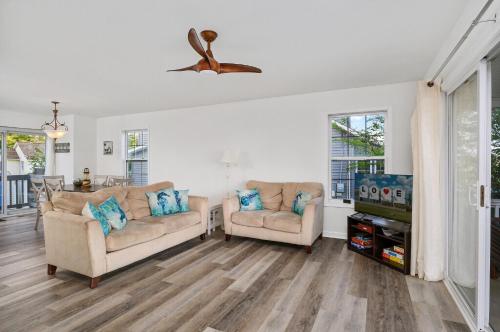 a living room with two couches and a tv at Lighthouse Overlook in Birch Town