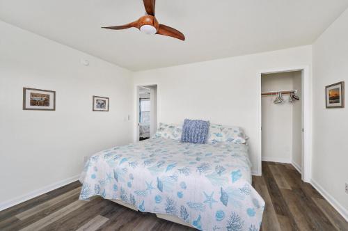 a bedroom with a bed and a ceiling fan at Lighthouse Overlook in Birch Town