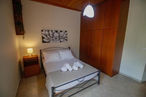 a bedroom with a bed with two white shoes on it at Fairy Dreams in Konitsa