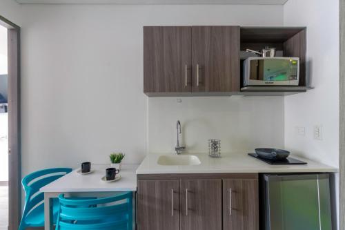 a kitchen with a sink and a microwave at Cozy and centrally located flat near Monserrate - 11005 in Bogotá