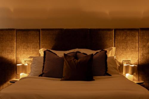 a bedroom with a large bed with two lamps at Moment Blythswood St in Glasgow