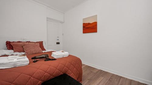 a bedroom with a bed with a red blanket at Elegant Escape in Covent Garden in London
