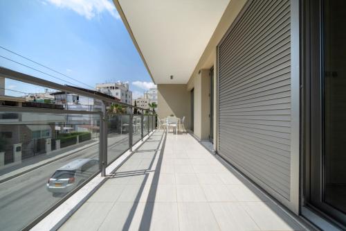 a balcony of a building with a car on the street at Central Luxurious 2 bedroom flat in Strovolos