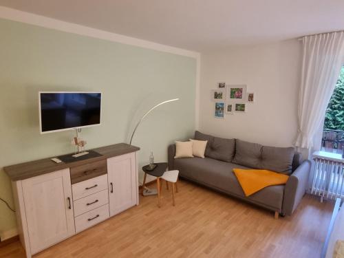 a living room with a couch and a flat screen tv at Auszeit Ferienwohnung in Bad Bevensen