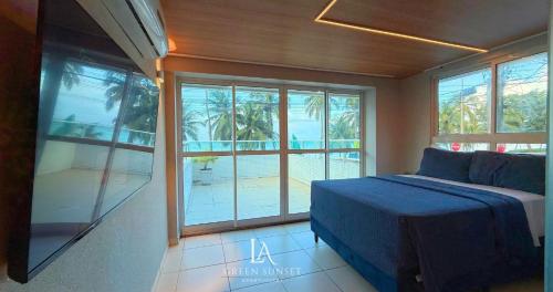 a bedroom with a bed and a large window at LA Green Sunset in João Pessoa