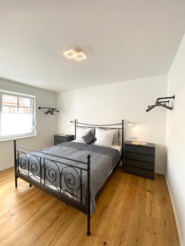 a bedroom with a bed and a wooden floor at Pastelani in Buckow