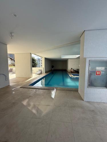 a large swimming pool in a building with a building at Mercure Boulevard Salvador Hotel 20 Andar in Salvador