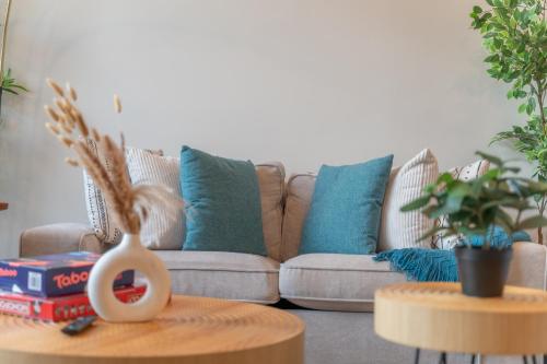 a living room with a couch with blue pillows at 2 Queen Bed with Free Parking, NYC View, Near Train Station in East Orange