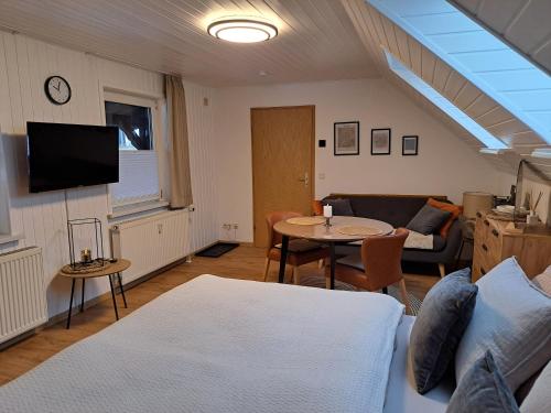a living room with a couch and a table at Ferienwohnungen Zur alten Dachdeckerei in Bad Bevensen