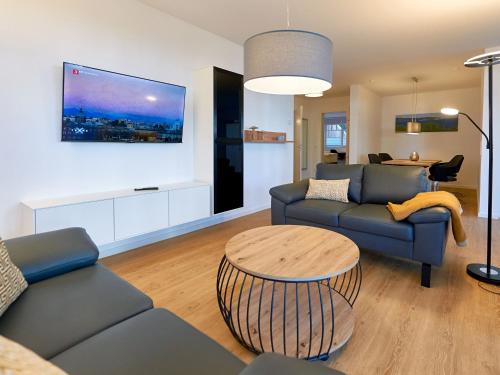 a living room with a couch and a table at Villa Beatrice - Wohnung 01 in Binz