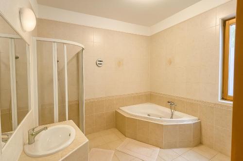 a bathroom with a tub and a toilet and a sink at Cozy Garden House in Budapest in Budapest