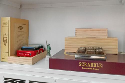 a shelf with books and a box on it at Midtown Bungalow in Reno