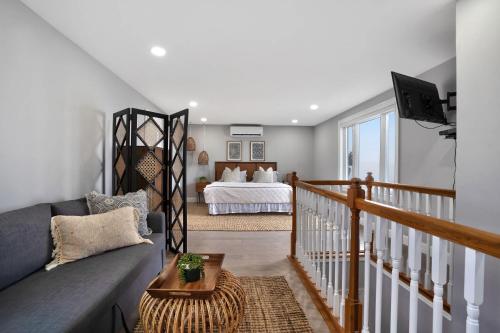a living room with a couch and a bed at Soundview Beach House: 4BR,Panoramic Views 1.5hrsNYC in Wading River