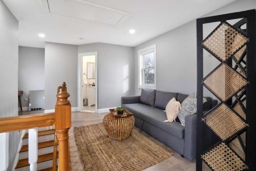 a living room with a blue couch and a table at Soundview Beach House: 4BR,Panoramic Views 1.5hrsNYC in Wading River