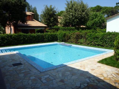 a swimming pool in the backyard of a house at Olivelli 1 in Palazzo Vianello