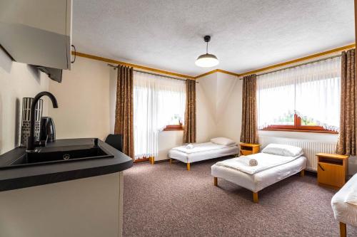 En eller flere senge i et værelse på Dom Wypoczynkowy NATALIA