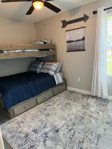 a bedroom with a bunk bed and a ceiling fan at The Nest at Lake Cumberland in Somerset