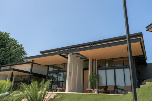 a house with glass walls and a roof at Epic Tamarindo Boutique Hotel in Tamarindo