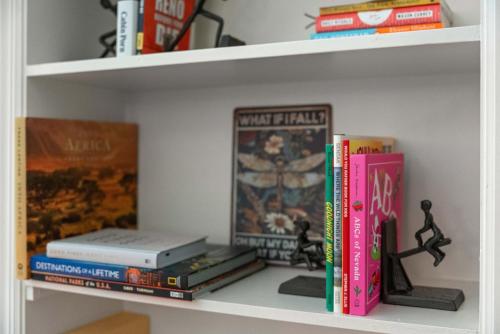 a shelf with a bunch of games and books at Midtown Bungalow in Reno