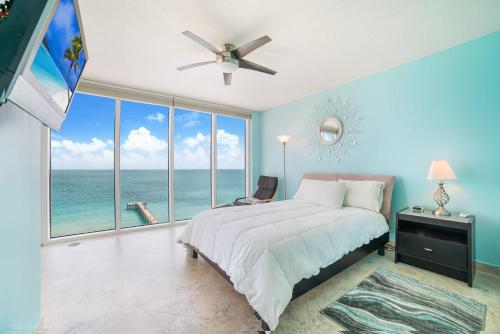 a bedroom with a bed with a view of the ocean at Balcony on the Ocean - Picture Perfect in Sunny Isles Beach
