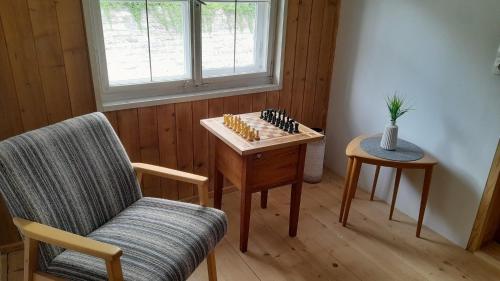 a living room with a chess board and a chair at Ferienhaus Bär in Bizau