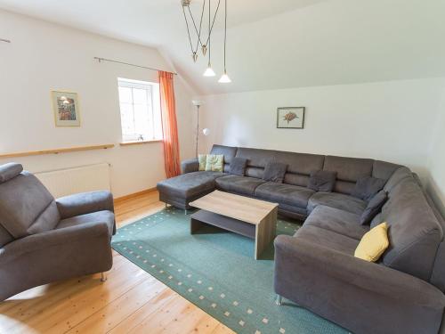 a living room with a couch and a coffee table at Ferienwohnung Komfort in Niedersachsen-Stadland