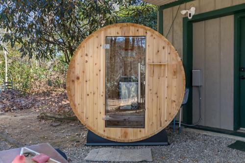 a large wooden circle sitting outside of a house at Rainbow Falls Cabin - Sauna - Hot Tub - Foosball in Sapphire
