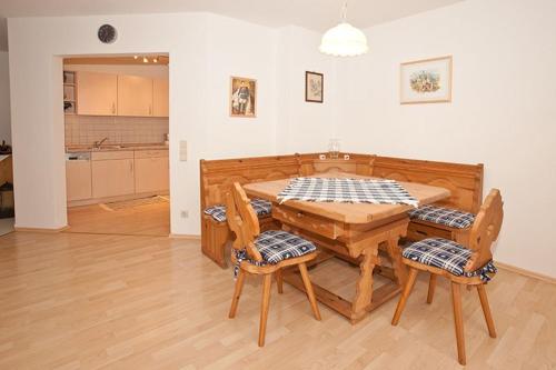 a wooden table and chairs in a living room at Ferienwohnung Birkenstraße Nesselwang 9 in Nesselwang