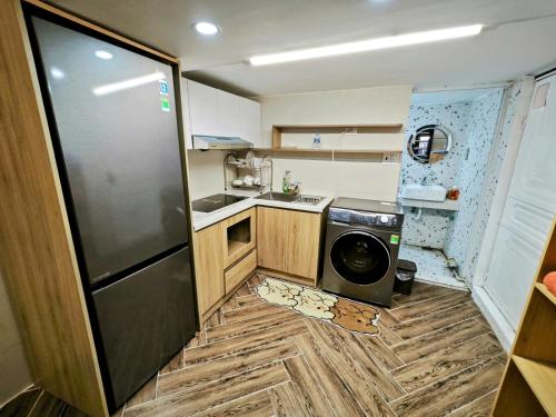 a small kitchen with a refrigerator and a dishwasher at Căn hộ tuyệt vời trung tâm Thành phố 2! in Hai Phong
