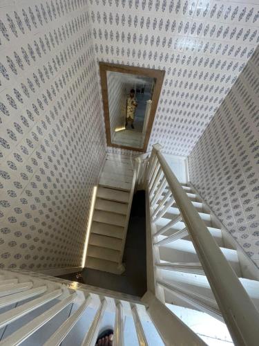 a staircase in a building with a person standing on it at Hostel e Pousada Sr Borba in Recife