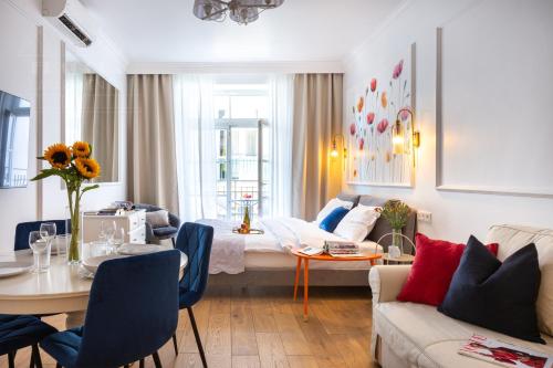 a living room with a bed and a table at Fragola Apartments Old Town in Kraków