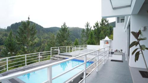 a balcony of a building with a swimming pool at Villa Sarungal Kanda in Bandarawela