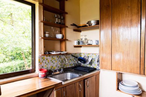 a kitchen with a sink and a window at Essence Arenal Spa & Yoga in El Castillo de La Fortuna