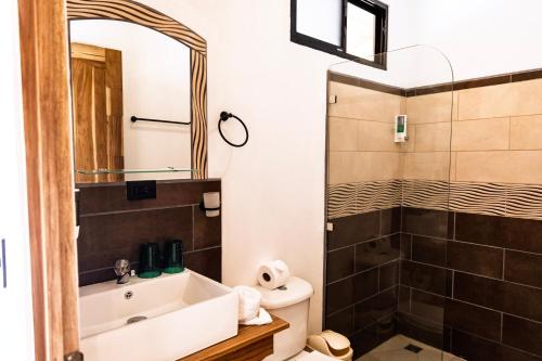 a bathroom with a sink and a shower at Essence Arenal Spa & Yoga in El Castillo de La Fortuna