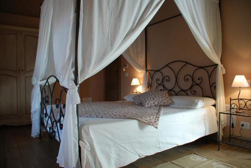 a bedroom with a bed with a canopy at La Carosera in Castellengo