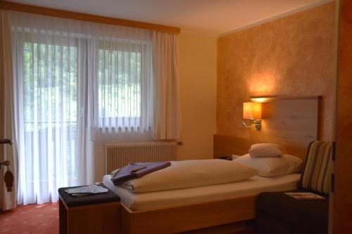 a bedroom with a bed and a large window at Tetter in Schladming