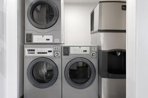 three washing machines and a washer and dryer at Holiday Inn Roanoke - Tanglewood Route 419 & I 581 by IHG in Roanoke