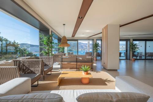 a living room with couches and a table at Leonardo Royal Hotel Mallorca in Palmanova