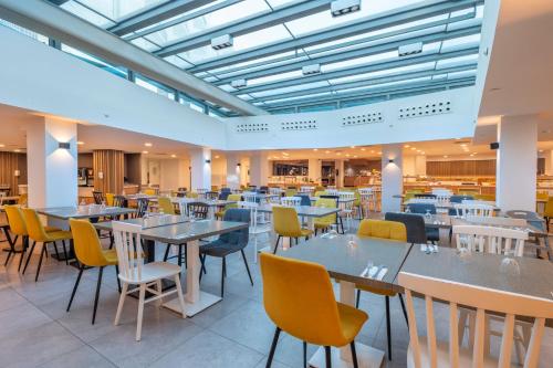 a dining room with tables and chairs at Leonardo Royal Hotel Mallorca in Palmanova